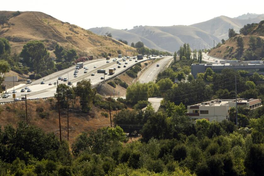 Urban wildlife specialists recommend building a tunnel under the 101 Freeway to provide safe passage for mountain lions, bobcats and other animals. Above, the 101 at Liberty Canyon.