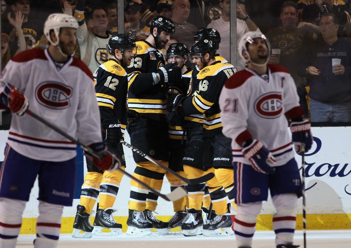 Members of the Boston Bruins celebrate a power-play goal by Jarome Iginla early in the second period against the Montreal Canadiens on Saturday night.