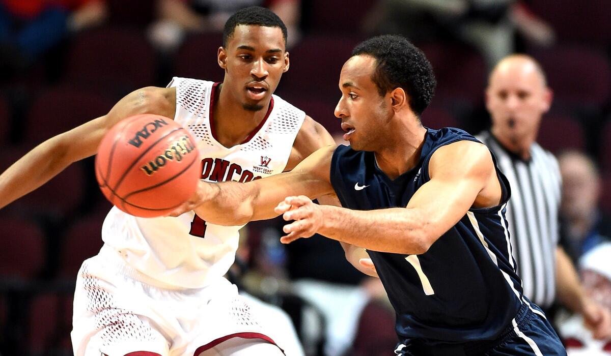 Loyola Marymount's Evan Payne passes the ball away from Santa Clara's Evan Wardlow during an opening-round game of the West Coast Conference basketball tournament at Orleans Arena in Las Vegas on Friday.