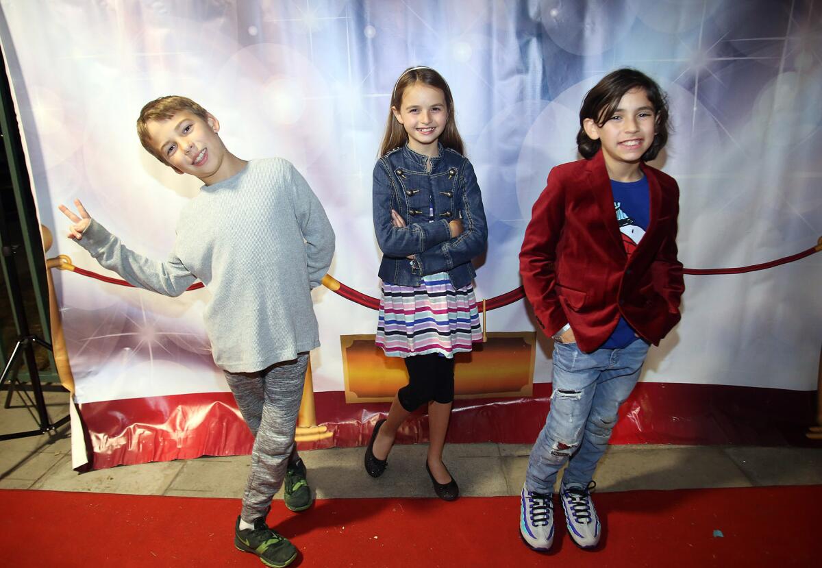Grady Pullin, 9, left, Hannah Dufour, 9, and Jamison Karp, 9, all fourth-grade filmmakers from Stevenson Elementary School, pose for pictures on the red carpet before the premiere of the second annual Fourth Grade Film Festival at Stevenson on Wednesday.