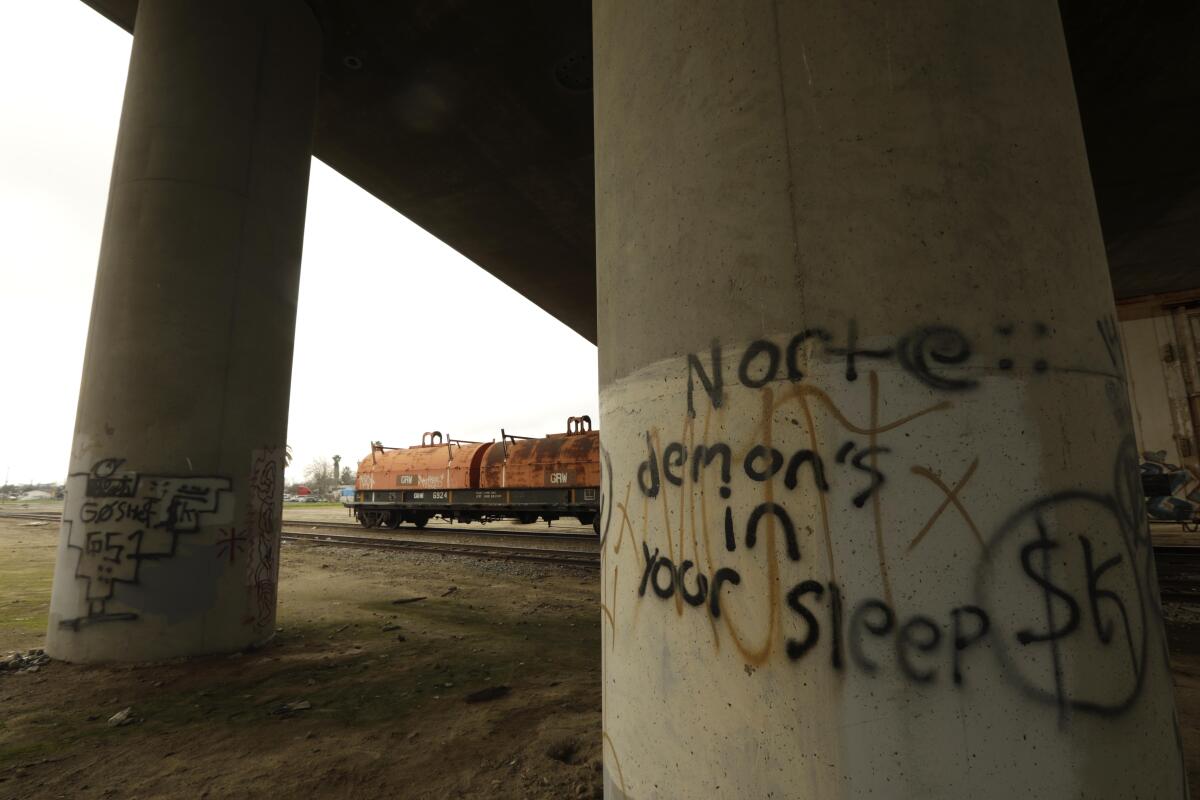 Graffiti on a column says, "Norte demons in your sleep."