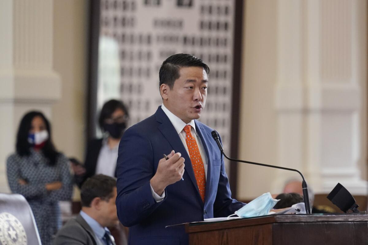 Texas state Rep. Gene Wu speaks into a microphone in the House chamber at the Capitol in Austin.