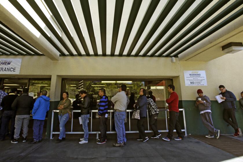 People stand at a DMV office in Los Angeles on Jan. 2, 2014.