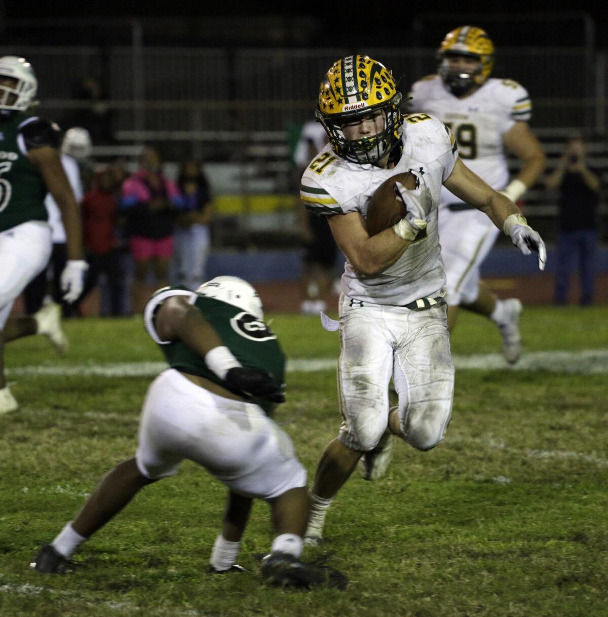 Edison's Troy Fletcher (21) runs around an Inglewood player for a first down in the fourth quarter.
