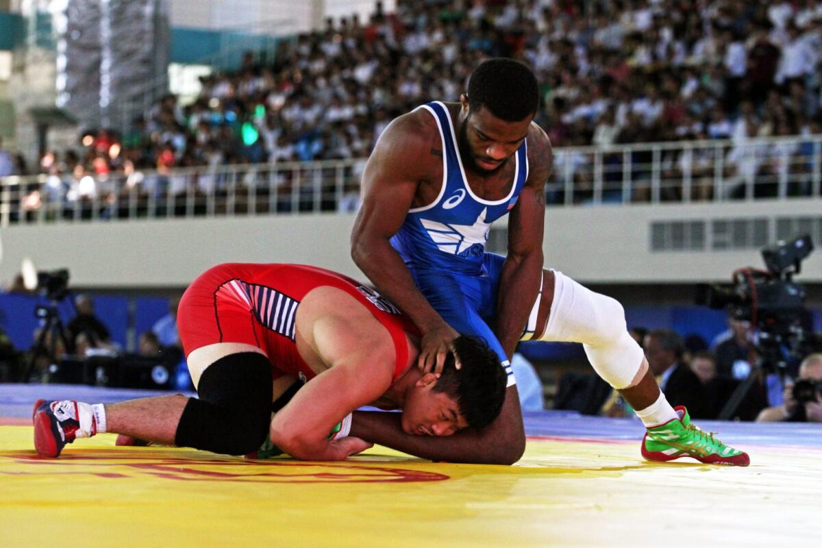U.S. wrestler Jordan Burroughs, right, takes on Yunseok Lee of Korea in the second round of the world wrestling campionships in Tashkent, Uzbekistan, on Tuesday.