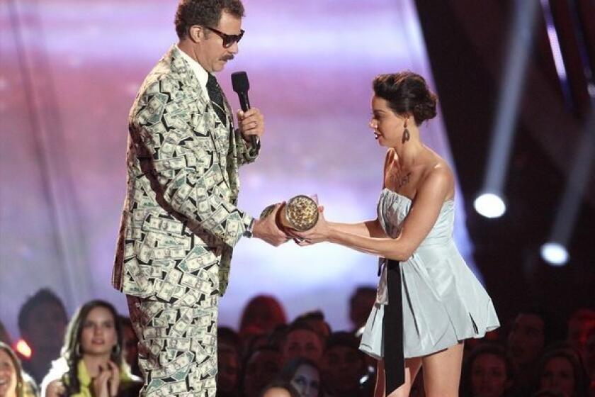 Aubrey Plaza tries to pull a Kanye West on Will Ferrell during the MTV Movie Awards on Sunday.
