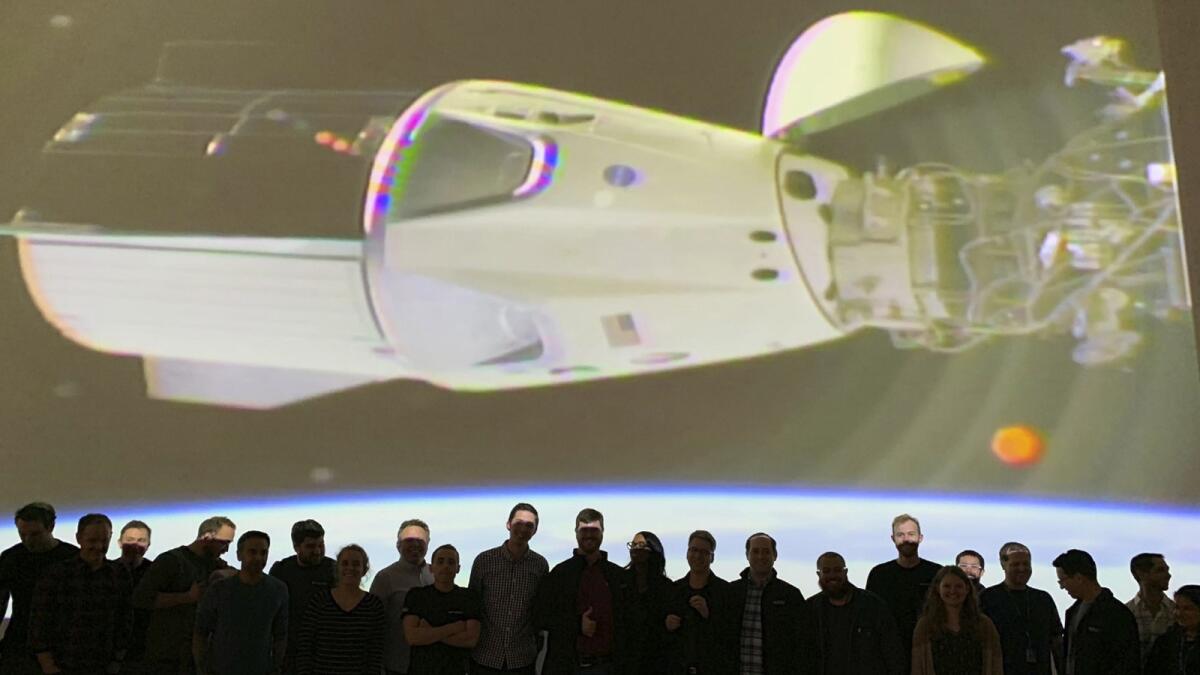 The SpaceX team in Hawthorne watches Sunday as the Crew Dragon docks with the International Space Station's Harmony module.