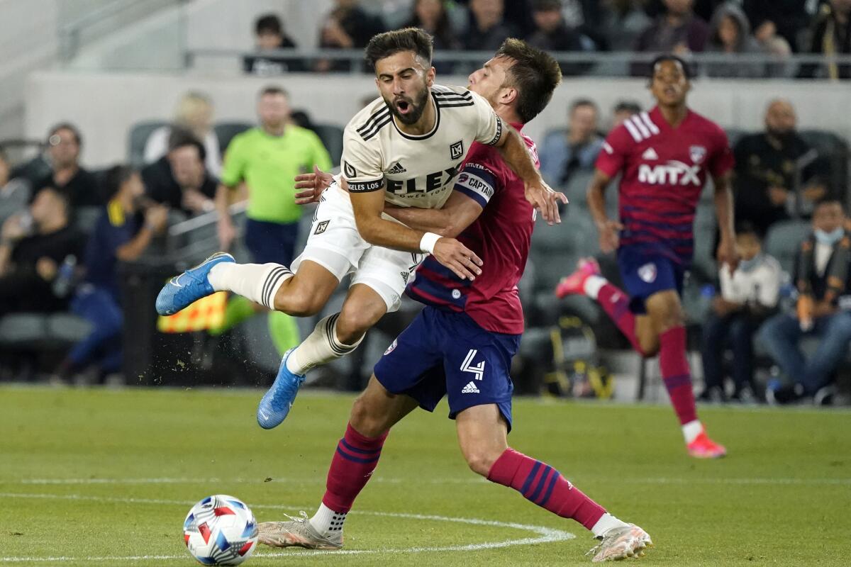 Los Angeles FC forward Diego Rossi, left, collides with Dallas FC defender Bressan 