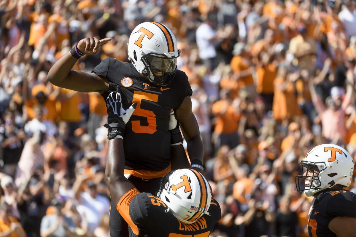 Tennessee quarterback Hendon Hooker is lifted in celebration after scoring a touchdown against South Carolina.