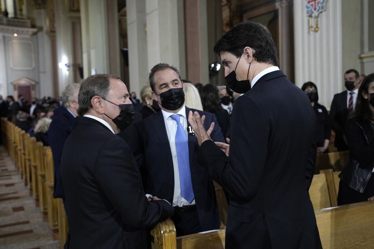 NHL Commissioner Gary Bettman, left, Montreal Canadiens President Geoff Molson, center, and Canada Prime Minister Justin Trudeau chat the the funeral service for former Montreal Canadiens NHL hockey player Guy Lafleur on Tuesday, May 3, 2022, in Montreal. (Paul Chaisson/The Canadian Press via AP)