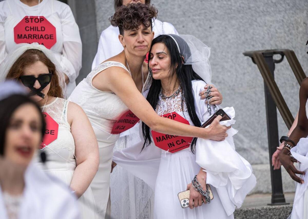Chavie Weisberger hugs fellow child marriage survivor Fatemah on the west steps of the California state Capitol.