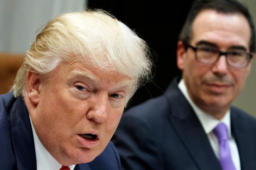 FILE - In this Feb. 22, 2017, file photo photo, Treasury Secretary Steven Mnuchin listens at right as President Donald Trump speaks during a meeting on the Federal budget in the Roosevelt Room of the White House in Washington. Trump wants to tackle tax reform, but the loss on health care deals a blow to that effort. The loss on health care deprives Republicans of $1 trillion in tax cuts, and the GOP is just as divided on what steps to take. (AP Photo/Evan Vucci, File)