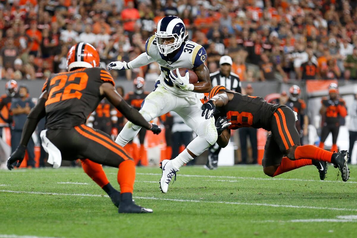 Rams running back Todd Gurley breaks a tackle by Cleveland's T.J. Carrie during Sunday's game.