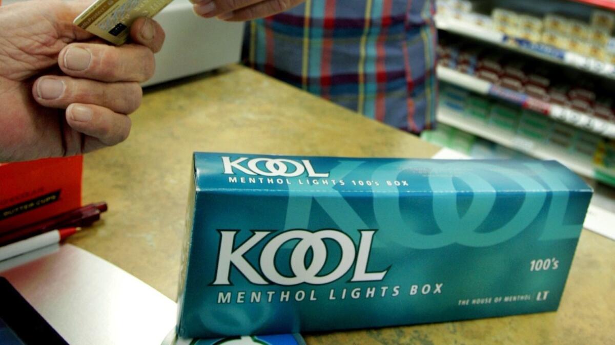 A customer buys a carton of menthol cigarettes at a store in Minneapolis in 2005.