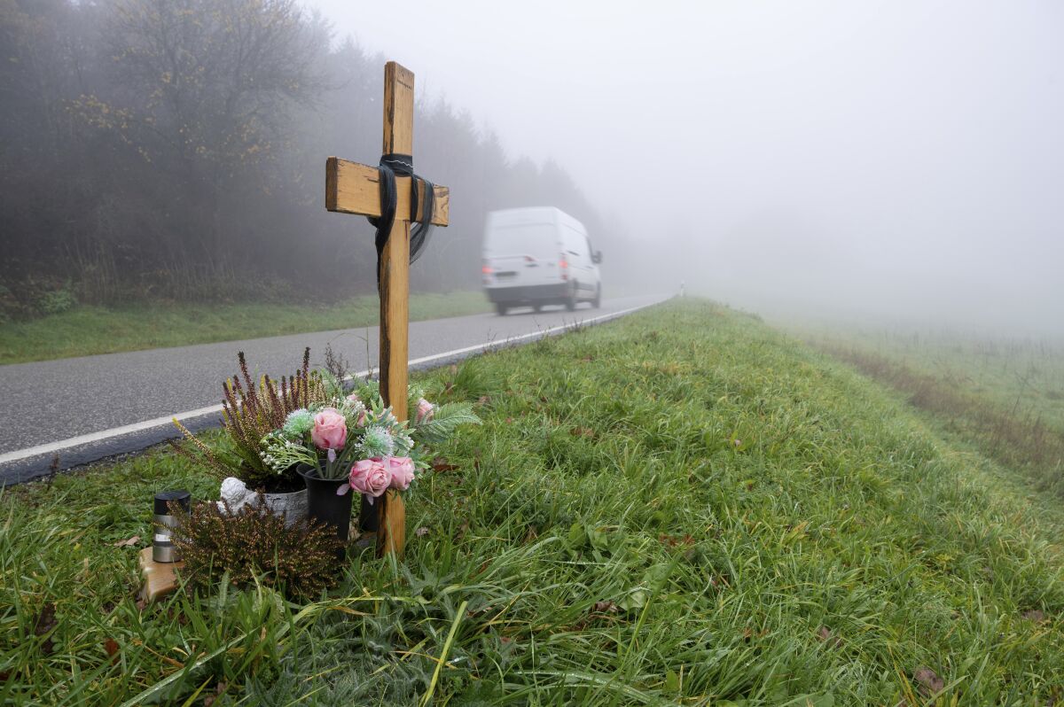 A wooden memorial cross stands at the spot where two police officers were killed in the line of duty at the end of January 2022 near the town Kusel, Germany, Tuesday, Nov. 29, 2022 . A court convicted a 39-year-old man of murder on Wednesday, Nov. 30, 2022, in the killing of two police officers who had stopped him and an accomplice on suspicion of poaching. A regional court in Kaiserslautern sentenced the defendant to life imprisonment. (Harald Tittelp/dpa via AP)
