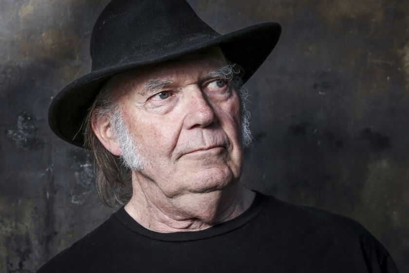 Neil Young wearing a black hat