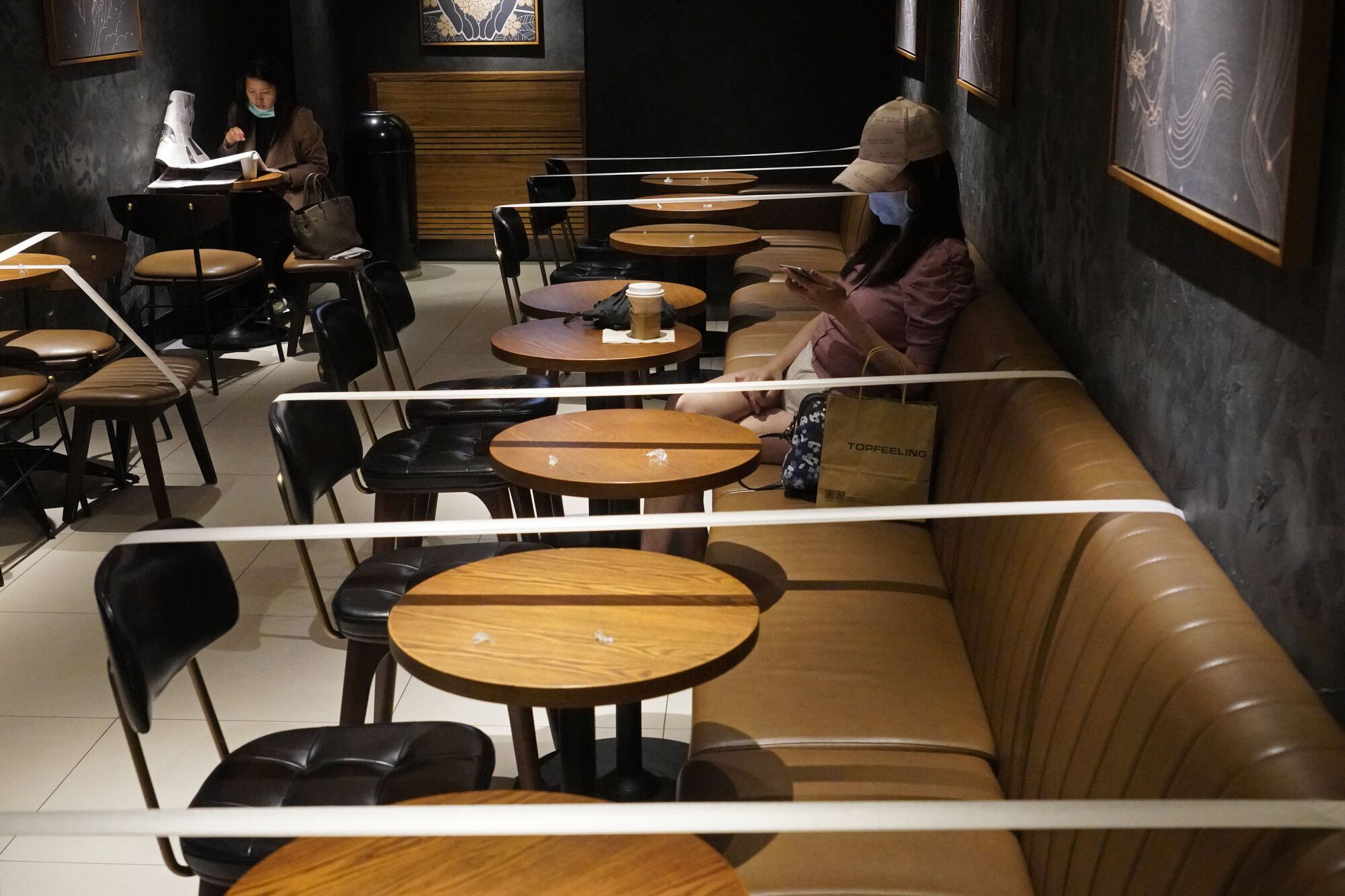 HONG KONG: Tables and chairs are taped for social-distancing law enforcement to help curb the spread of the coronavirus at a Starbucks coffee shop.
