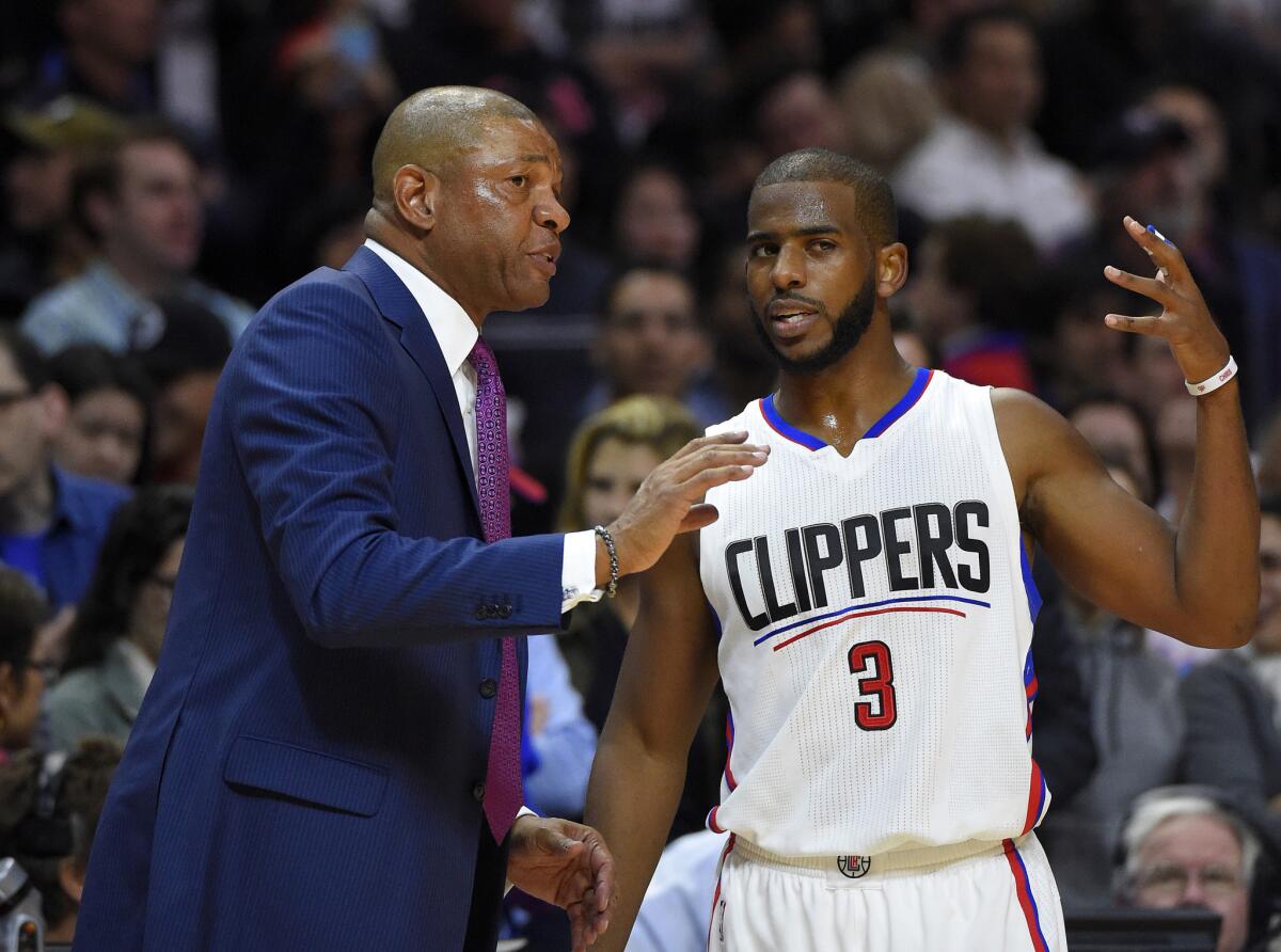 Clippers Coach Doc Rivers talks with guard Chris Paul during the second half of a game against the Memphis Grizzlies on Nov. 9.
