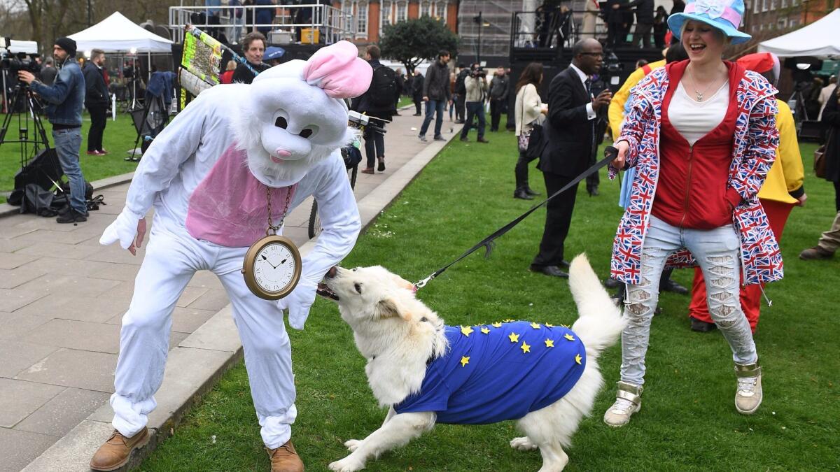 Protesters depicted as "Mad Tea Hatters" demonstrate against Brexit outside the Houses of Parliament in London on March 29, 2017.