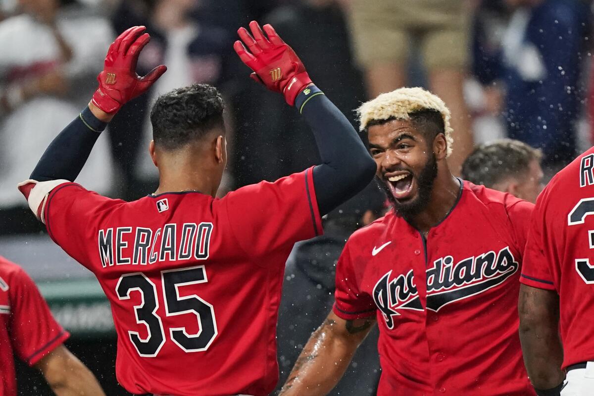 Cleveland Indians' Bobby Bradley, right, is congratulated by Oscar Mercado after Bradley hit a solo home run in the ninth inning of a baseball game against the Kansas City Royals, Friday, July 9, 2021, in Cleveland. (AP Photo/Tony Dejak)