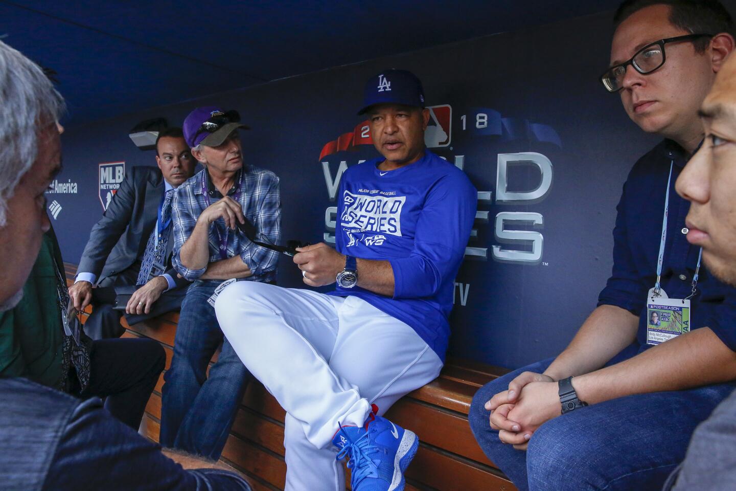 Dodgers manager Dave Roberts chats with reporters in the dugout hours before game five.