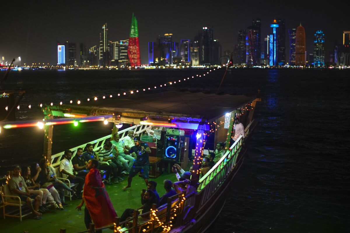 People dance in a wooden boat in Doha, Qatar.