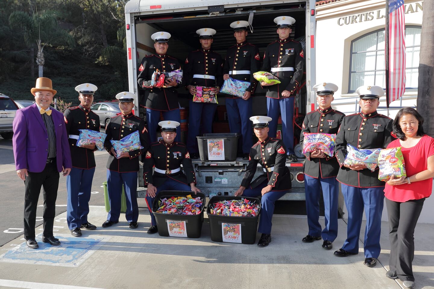 Dr. Curtis Chan and his wife Mae flank Marines from Camp Pendleton who came to collect the candy