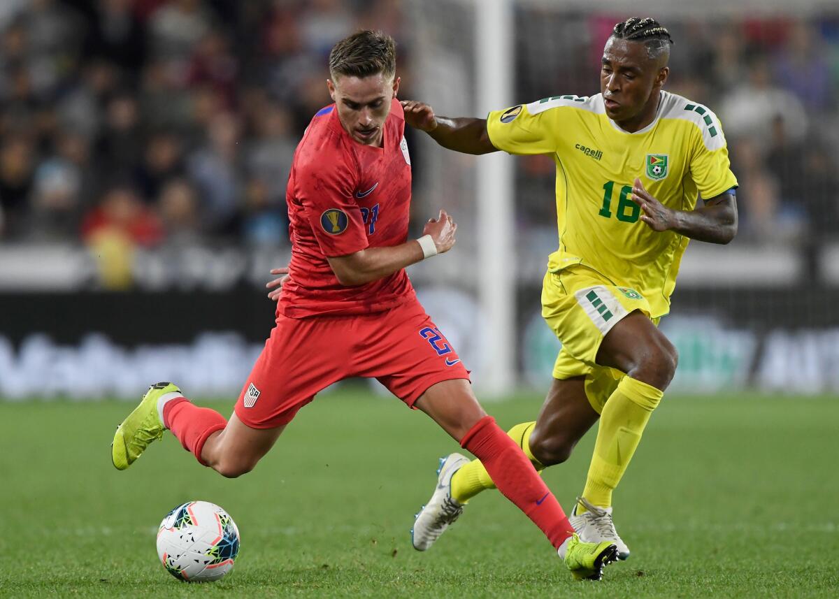 Guyana's Neil Danns, right, defends against United States' Tyler Boyd during the first half of the Gold Cup match on Tuesday in St Paul, Minn. The United States defeated Guyana 4-0.