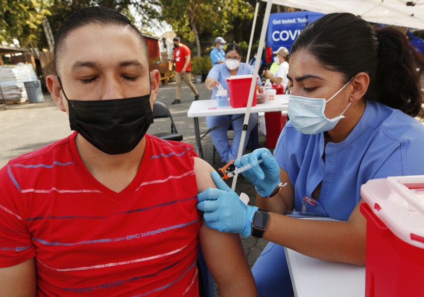 Pedro Antonio Tobar Mendoza, 28, visiting from El Salvador gets the Johnson and Johnson vaccine.