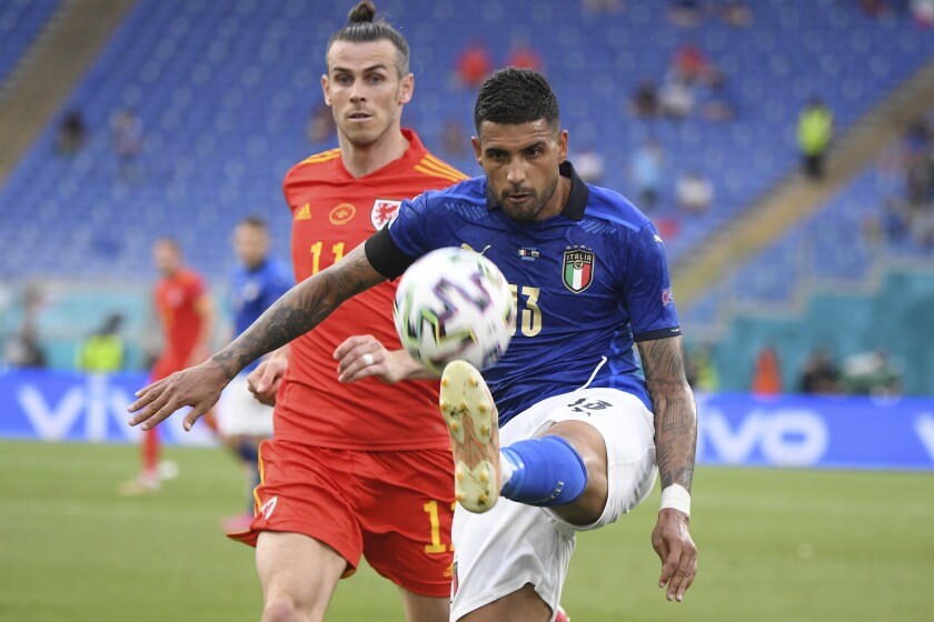 Italy's Emerson Palmieri is challenged by Wales' Gareth Bale, rear, during the Euro 2020 soccer championship group A match between Italy and Wales at the Stadio Olimpico stadium in Rome, Sunday, June 20, 2021. (Alberto Lingria/Pool via AP)