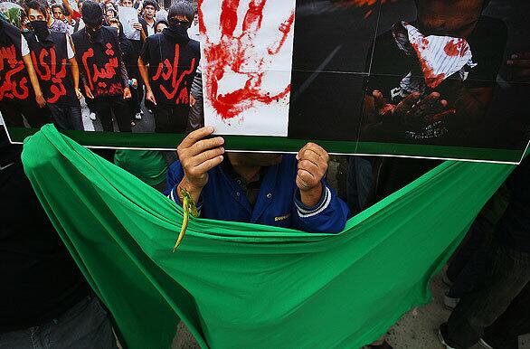 Demonstrators hold signs and banners, expressing opposition to the violence that has broken out in the streets of Iran.