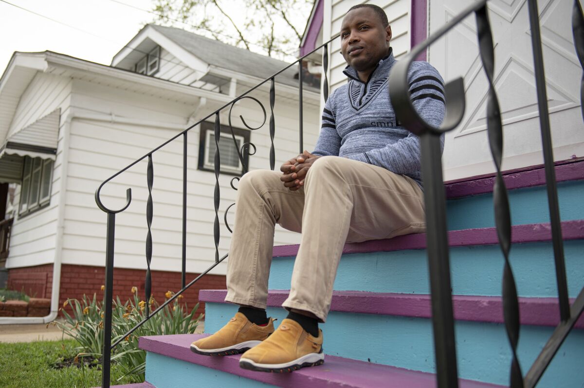 Victor Harerimana poses for a photograph in Cleveland on May 4, 2022. Harerimana is a Congolese refugee who used the Microenterprise Development program to launch Equity Languages and Employment Services, a business he co-owns. (Michael Indriolo via AP)
