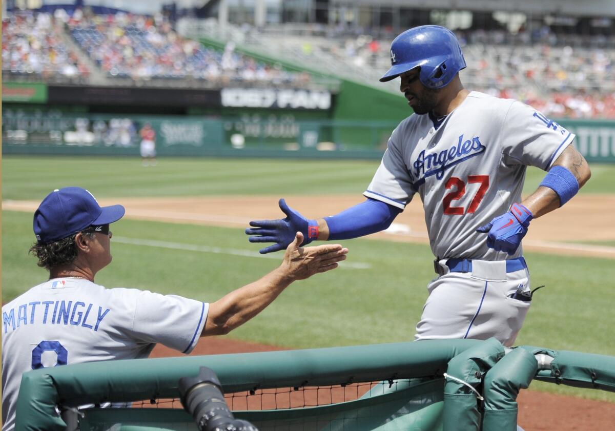 Dodgers center fielder Matt Kemp is congratulated by Manager Don Mattingly after hitting a home run Sunday in his first at-bat since coming off the disabled list.