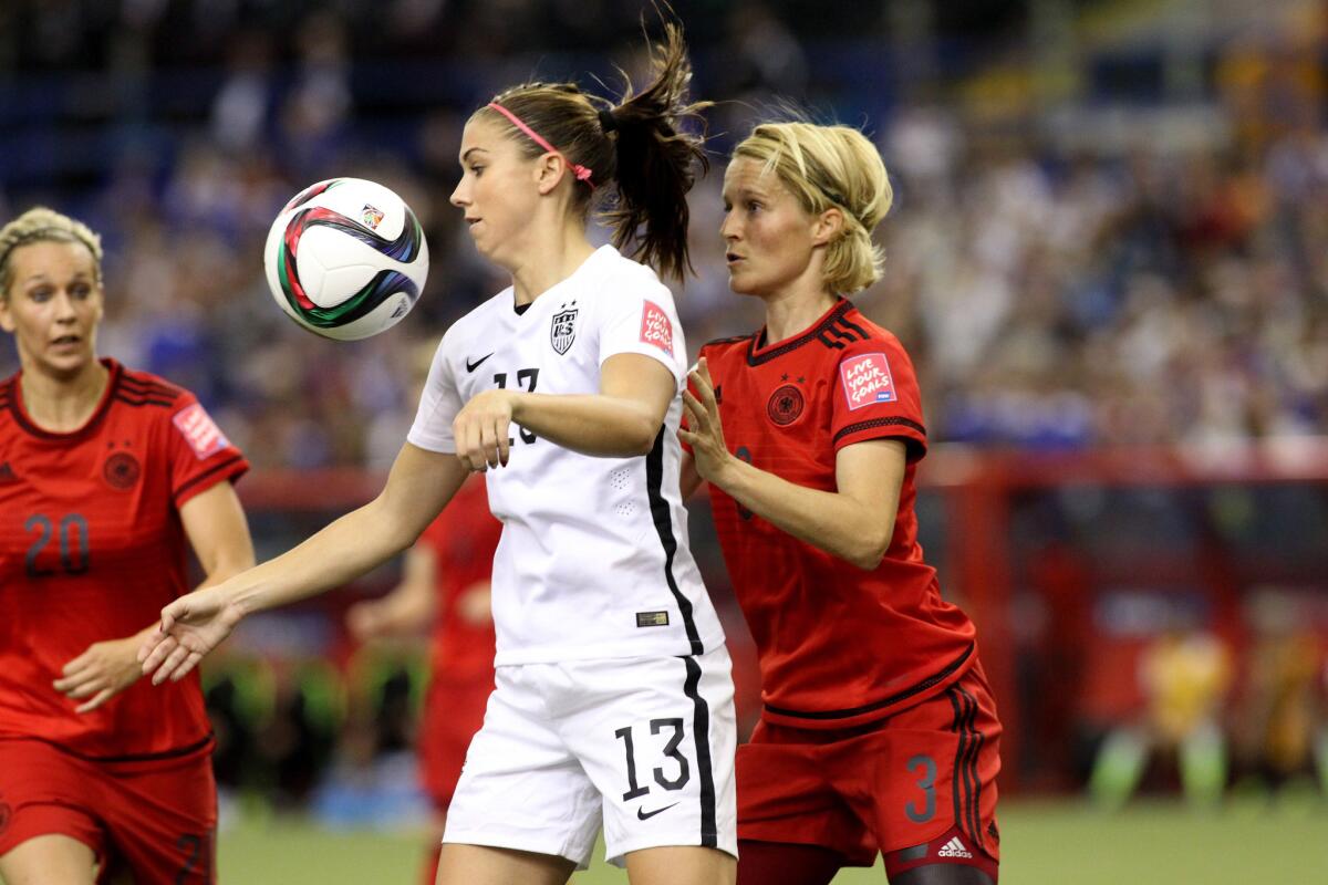 U.S. forward Alex Morgan gets control of the ball in front of German defender Saskia Bartusiak during the first half of a semifinal match at the Women's World Cup.