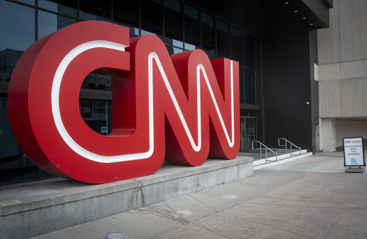 FILE - The CNN logo is displayed at the entrance to the CNN Center in Atlanta on Feb. 2, 2022. Cable news ratings are down across the board compared to 2022, when Russia's invasion of Ukraine was in the news. CNN's dip is most dramatic — 61% in prime-time in March. (AP Photo/Ron Harris, File)