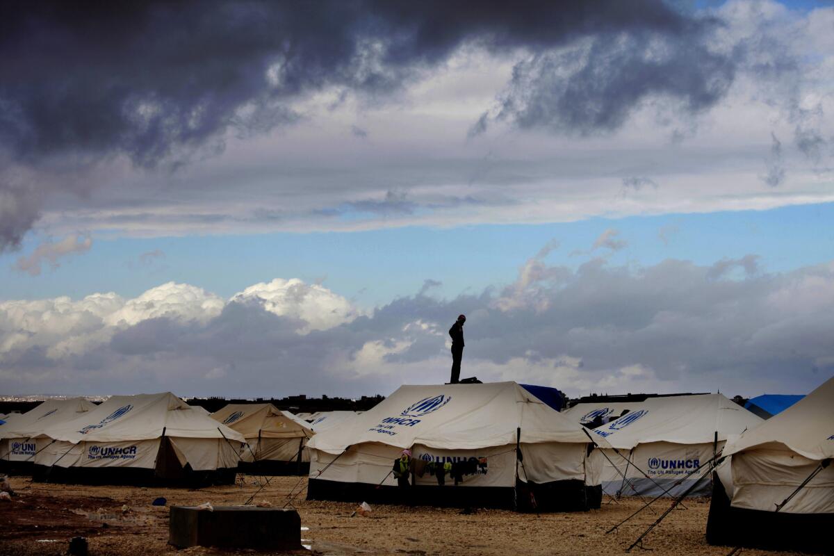 A Syrian refugee stands on top of a water tank at Zaatari refugee camp in Mafrag, Jordan near the Syrian border on Jan. 9.