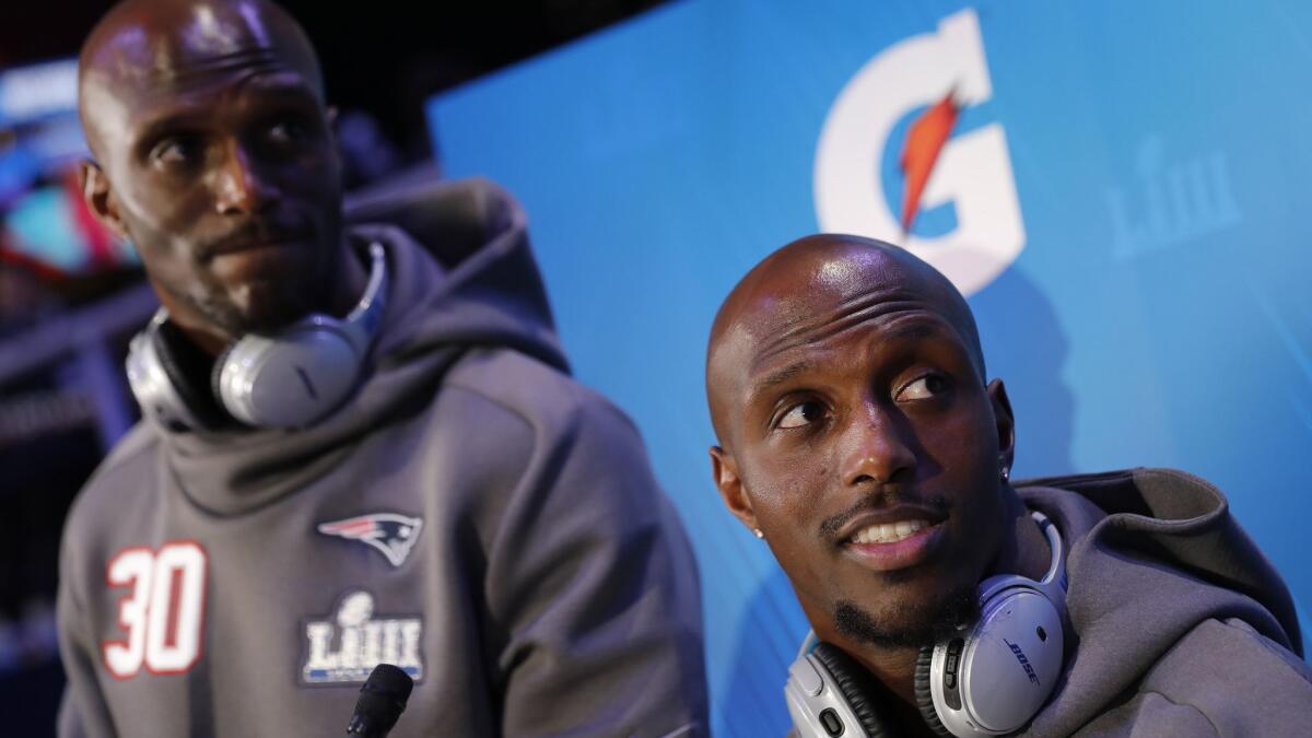 New England Patriots' Jason McCourty and Devin McCourty answer questions during media night for Super Bowl LIII in Atlanta.