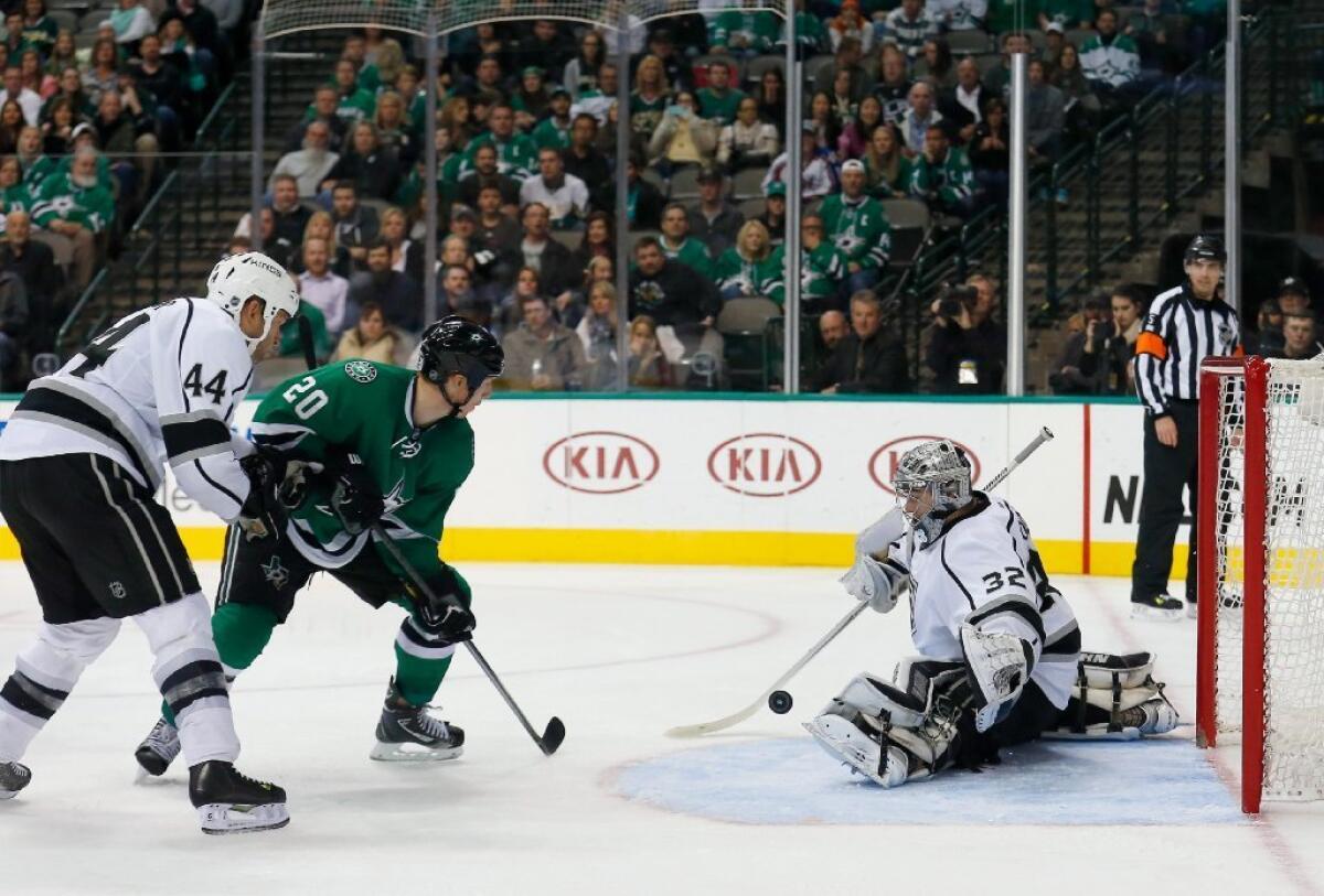Dallas' Cody Eakin puts a shot on Jonathan Quick as Robyn Regehr defends in the Kings' 5-4 loss to the Stars.