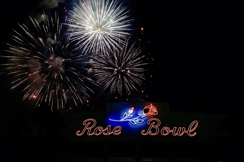 Fireworks explode over the Rose Bowl sign