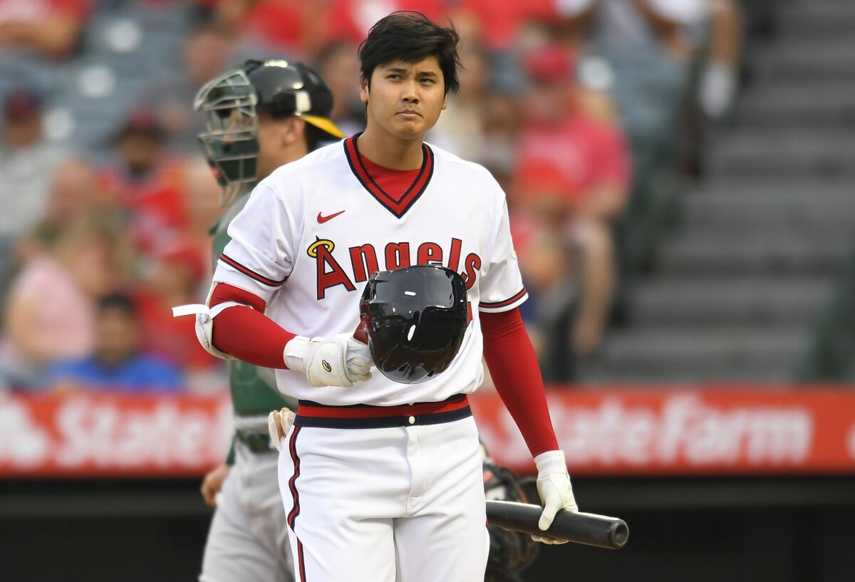 The Angels' Shohei Ohtani walks to the dugout after striking out in the first inning July 30, 2021.