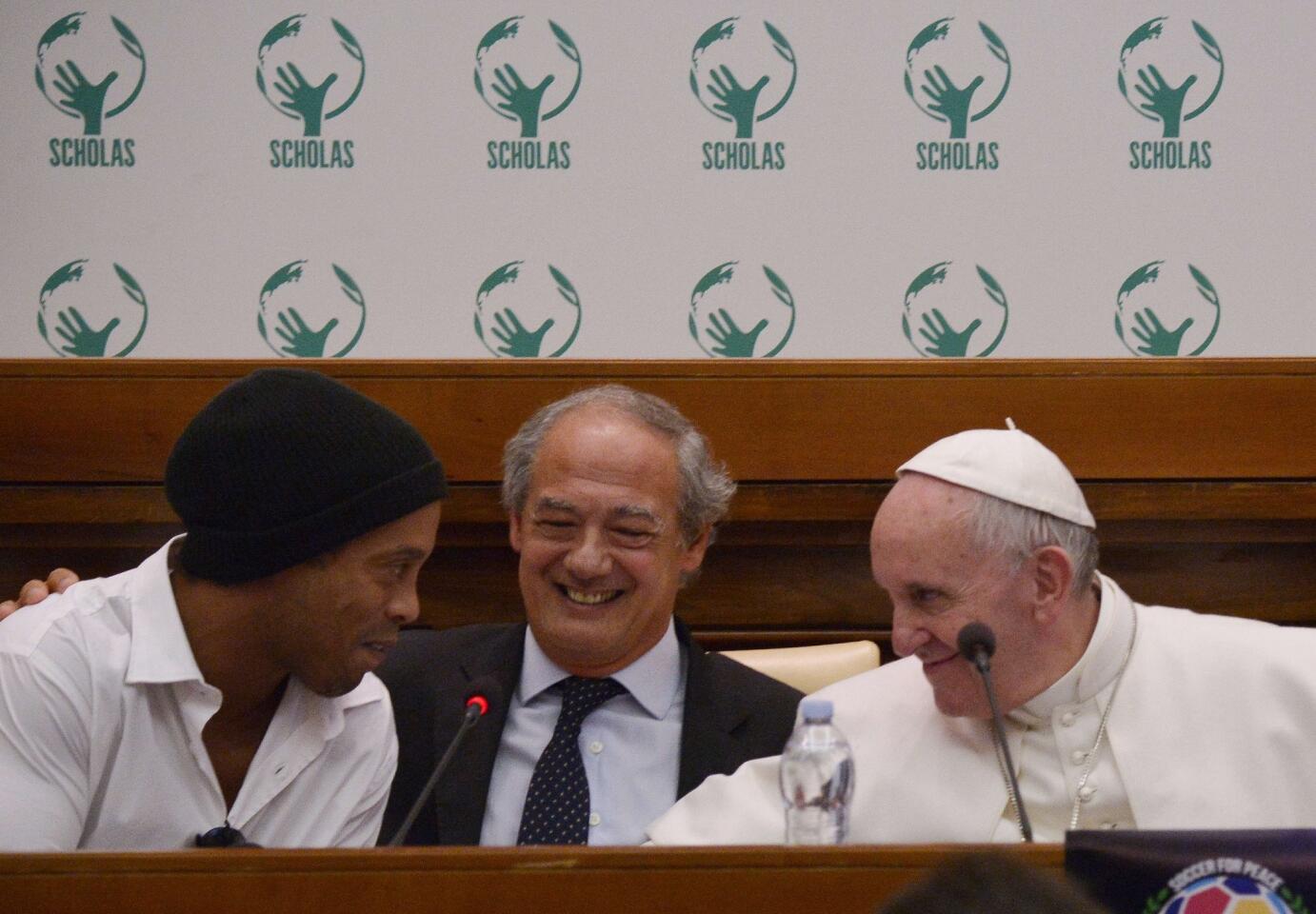 Brazilian football star Ronaldinho (L) arrives for a meeting with Pope Francis and the directors of "Scholas Occurentes" organization, to support a charity football match "For Peace" with international players, on February 3, 2016 at the Vatican. The "Scholas Occurrentes" organization is an international project based in Argentina that brings together schools and educational networks from different cultures and beliefs. AFP PHOTO / TIZIANA FABITIZIANA FABI/AFP/Getty Images ** OUTS - ELSENT, FPG, CM - OUTS * NM, PH, VA if sourced by CT, LA or MoD **
