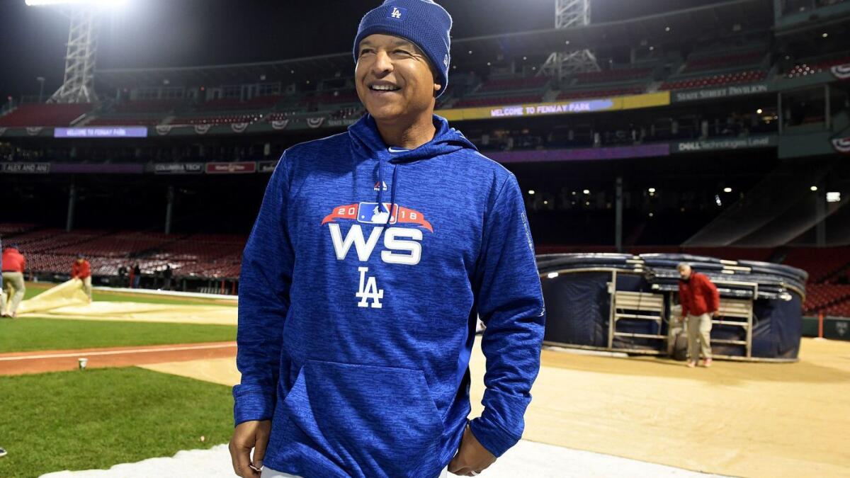 Dodgers manager Dave Roberts smiles after a workout at Fenway Park in Boston on Monday.