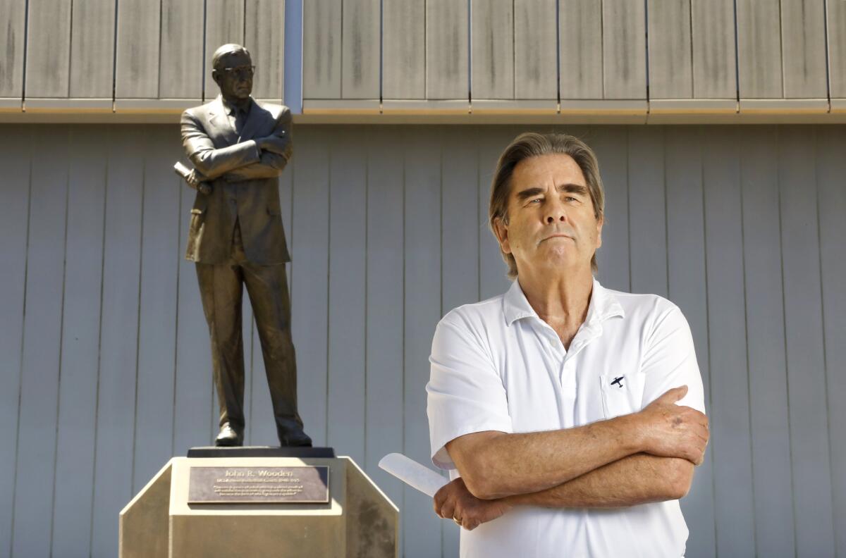 Beau Bridges, posing with the John Wooden statue at UCLA, will portray his former coach in a new play.