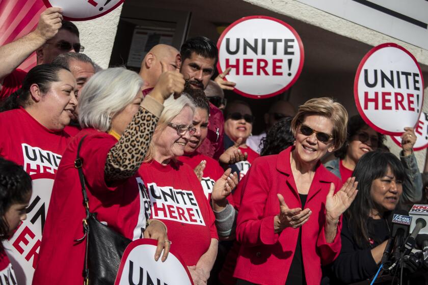 INGLEWOOD, CALIF. -- TUESDAY, DECEMBER 17, 2019: Presidential candidate and Senator Elizabeth Warren, right, cheers at press conference at UNITE HERE Local 11 headquarters as labor agreement was announced between the union and food service provider Sodexo in Inglewood, Calif., on Dec. 17, 2019. (Brian van der Brug / Los Angeles Times)