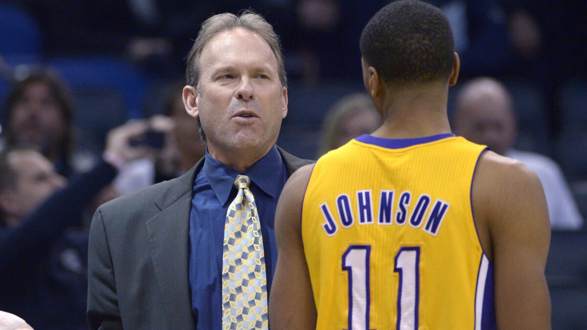Lakers assistant coach Kurt Rambis, left, speaks with small forward Wesley Johnson during a game against the Orlando Magic in January. The Lakers have interviewed Rambis for their head coaching position.