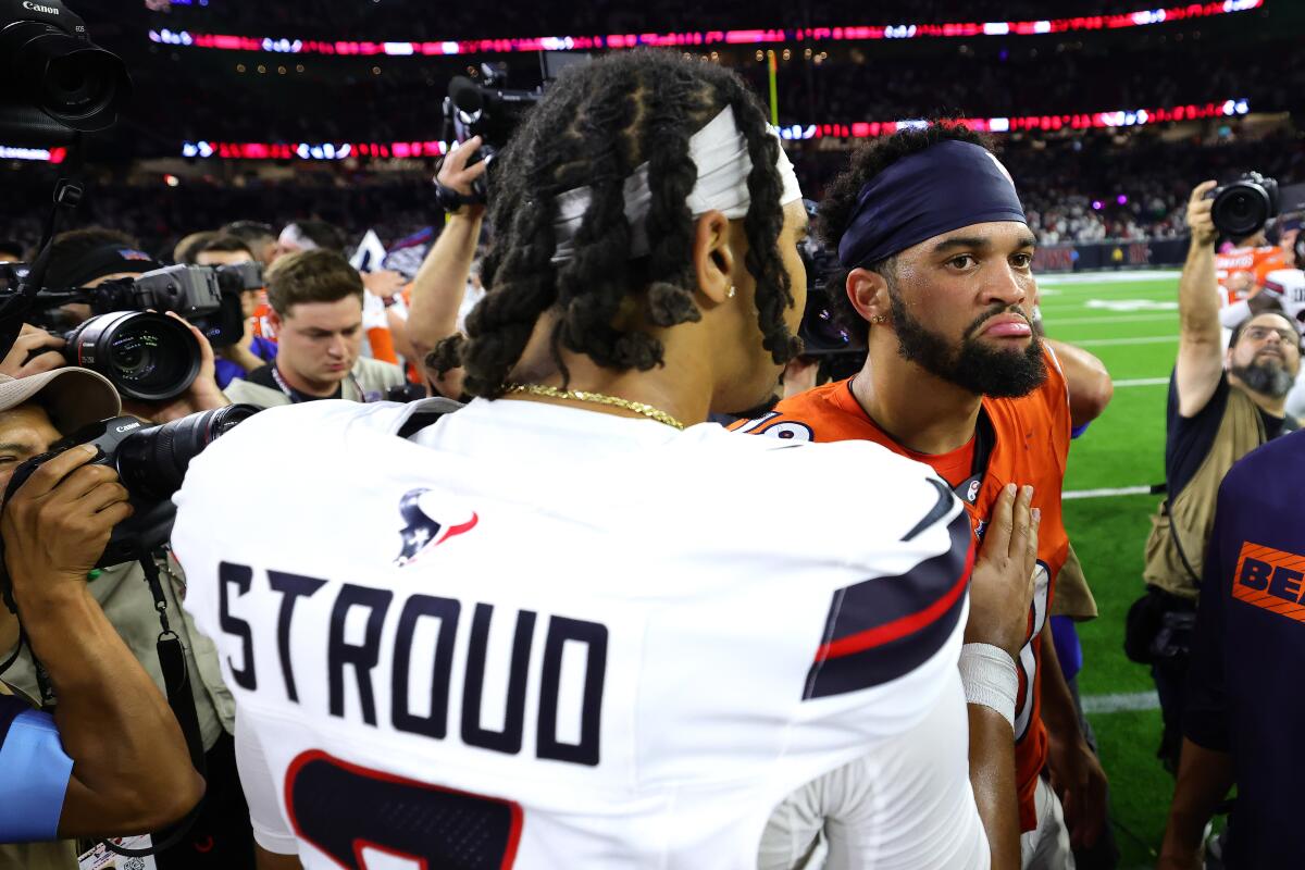 Texans quarterback C.J. Stroud talks to Bears quarterback Caleb Williams on the side line after a football game