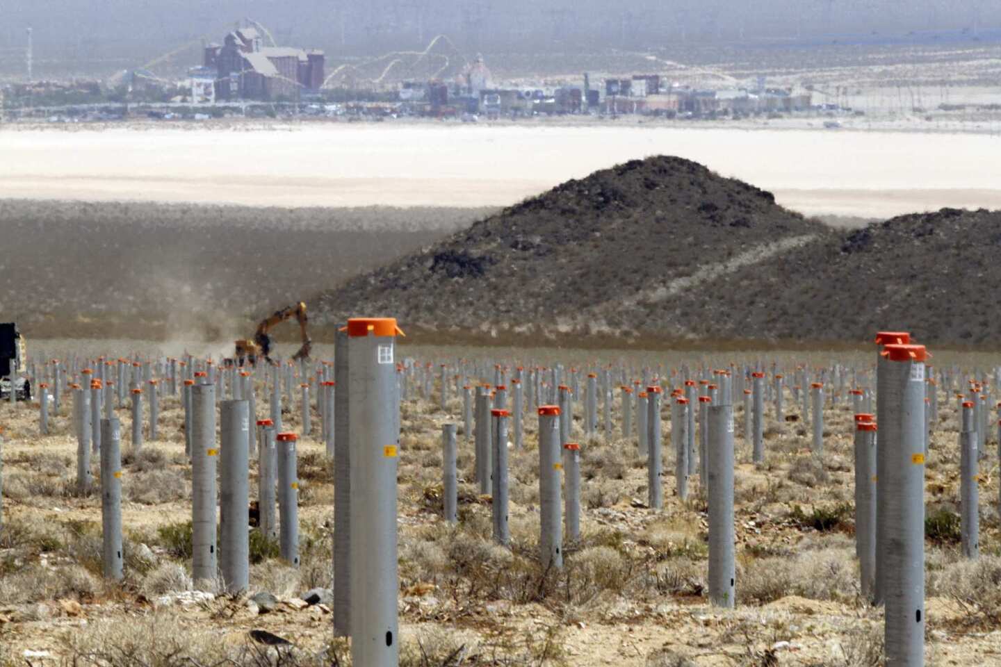 The casinos and shopping center at the Nevada state line provide the background for the posts that will support the mirror structures, called heliostats, at the solar plant.