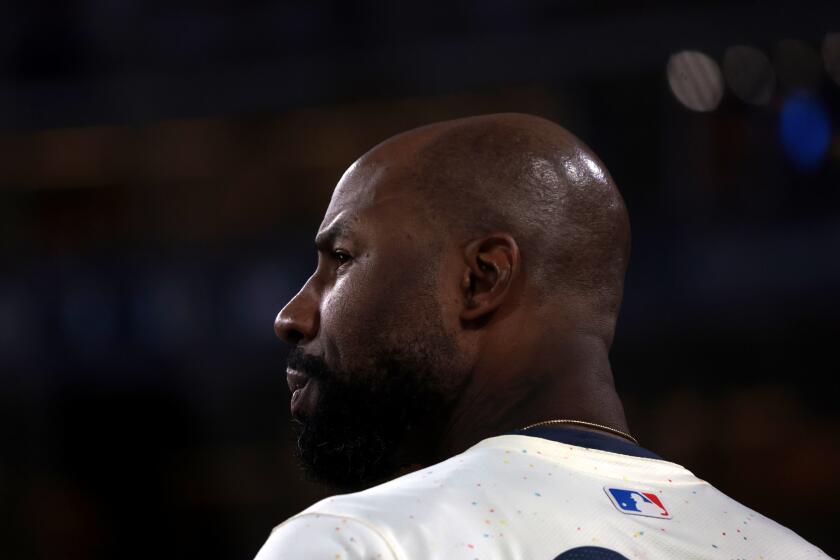 LOS ANGELES, CALIFORNIA-Dodgers Jason Heyward watches form the dugout against the Angels at Dodgers Stadium Saturday. (Wally Skalij/Los Angeles Times)