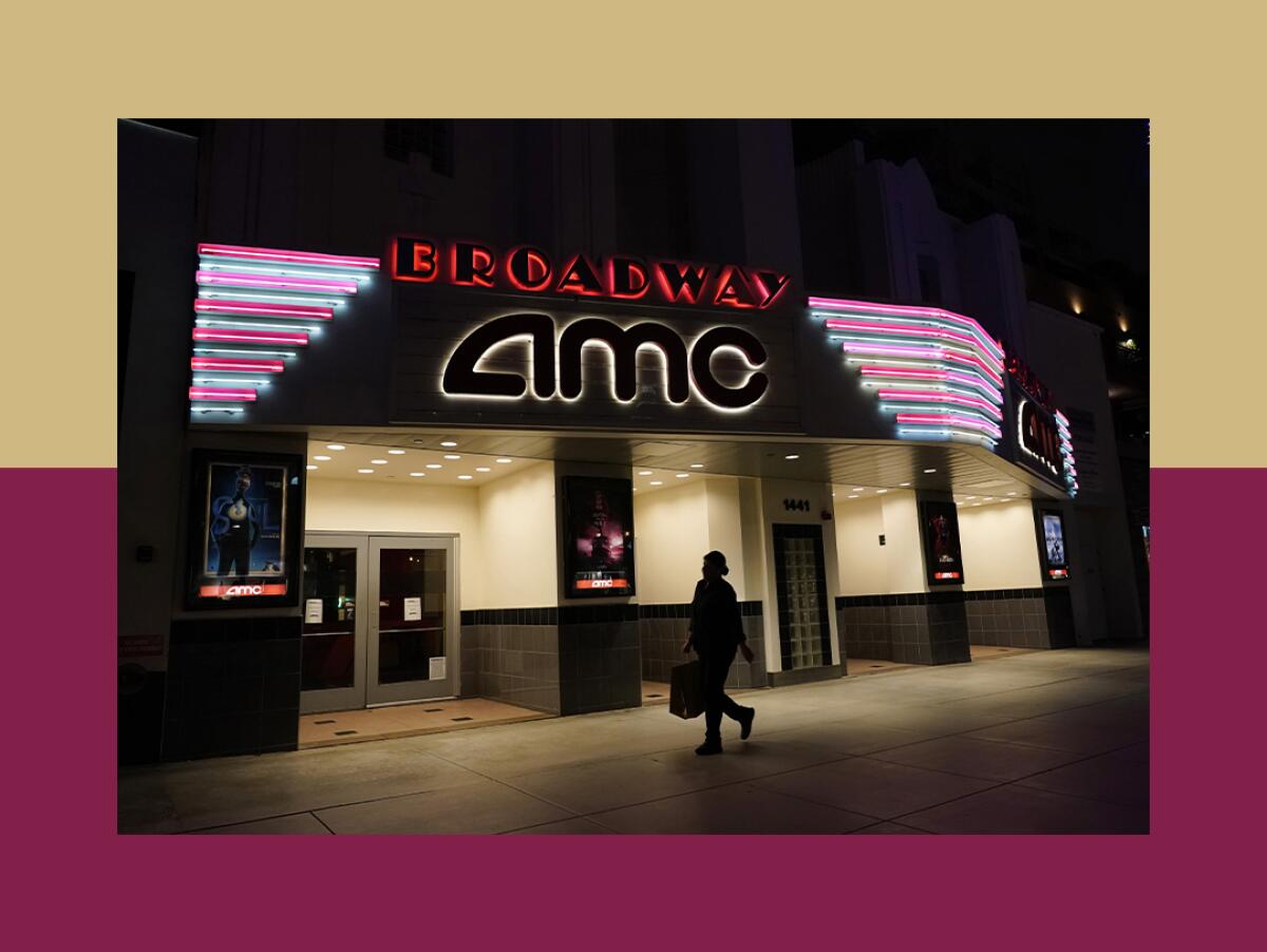 A shopper walks past a closed AMC movie theater.