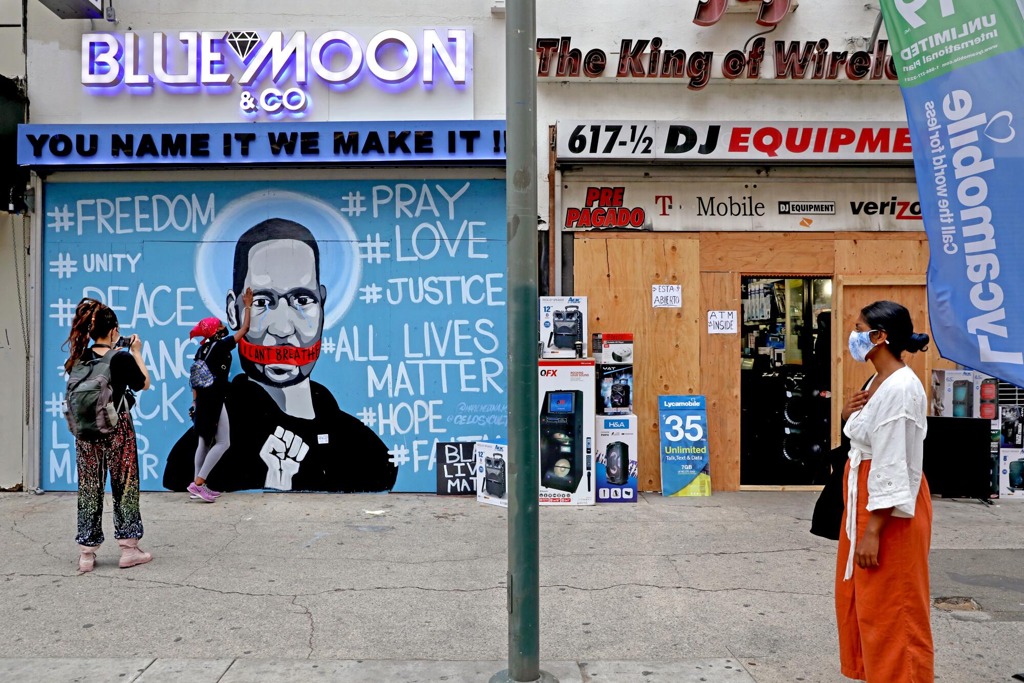 A mural of George Floyd by artist Mario Medina, with assistance by Celos, on South Broadway in downtown Los Angeles.